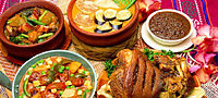 A variety of Filipino food, including kare-kare, pinakbet, dinuguan, and crispy pata