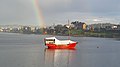 A ketch on Llanquihue Lake, with a rainbow in the background
