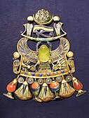 A pendant in the shape of a winged scarab carrying the Eye of Horus, from the treasury