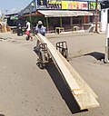 Transport of planks with a hand cart in Douala, Cameroon