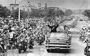 While visiting Taipei, Taiwan in June 1960, U.S. President Dwight D. Eisenhower waves to crowds Taiwanese people from an open car next to Chiang Kai-shek.