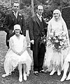 Men in morning dress and women in wedding gowns at a wedding (1929)