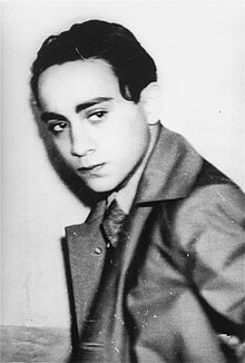 A concerned-looking Grynszpan, wearing an overcoat