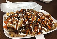 Halal snack pack, an Australian fast food dish of doner kebab meat and chips with sauces.