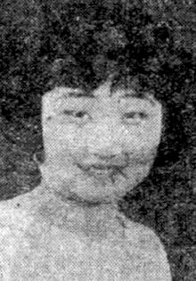 A newspaper photograph of a smiling young Asian woman with bangs and a bobbed haircut.