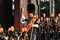 The U.S. Army Band drum-major shown with choir behind him.