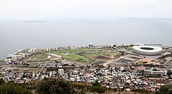 Mouille Point along the coastline with Green Point in the foreground. Robben Island in the distance, left
