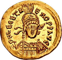 Gold coin showing the bust of a male figure dressed in military garb. His figure is encircled by text.