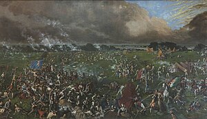 The painting shows many men, some on foot and some on horseback, engaged in hand-to-hand combat. One man carries the Mexican flag; another carries the flag of the Republic of Texas. In the background are several tents; behind them is a body of water.