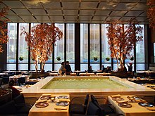 An overview photograph of the Four Seasons Restaurant room with the trees and the pool