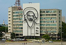 Monument to Camilo Cienfuegos on a building in Havana. It says "Vas bien, Fidel" on it.