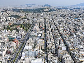 Aerial view of the city in the foreground with the Acropolis of Athens in the background