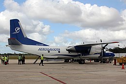 The white and blue An-26 aircraft parked at Antonio Maceo Airport