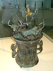 Dian vessel depicting a horseman surrounded by four oxen being hunted by tigers