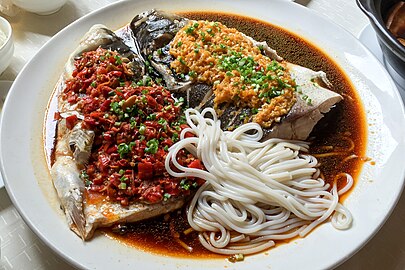 Duo jiao yu tou (剁椒鱼头), steamed bighead carp, served with noodles, Hunan cuisine