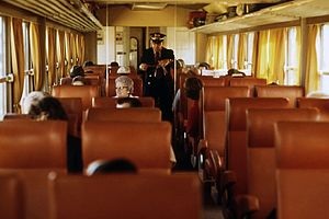 A conductor collects tickets aboard a Midwestern Turboliner in 1974.