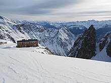 mountain refuge overlooking snow-covered Swiss mountains