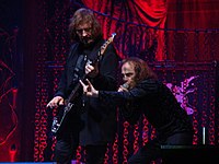 Vocalist Ronnie James Dio (on the right) making the sign at a Heaven & Hell concert in 2009. To his right is Geezer Butler. The gesture is quite common within heavy metal culture.