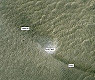 Dust Devil, as shown from HiRISE. Dust devil is moving to the upper left, leaving a dark track to the lower right. The shadow of the dust devil is to the upper left of the dust devil.