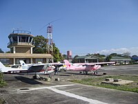 Control tower of Plaridel Airport and parked planes of the aviation schools located at the airport