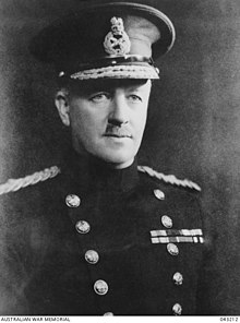 Head and shoulders of man in uniform with high collar and peaked cap.