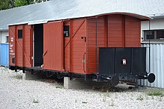 Photograph of a restored train car, with its sliding door open, used to transport Slovak Jews
