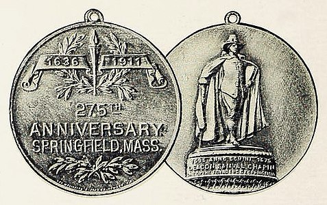 The statue on the reverse side of the city's 275th anniversary medallion