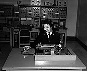 WAVE yeoman transcribing dictation from a dictation machine. Note yeoman's headphones and the dictation machine on the desk.