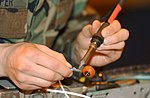 (De)soldering a contact from a wire.
