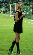 Sports anchor wearing little black dress and knee-high boots, Mexico, 2010