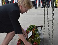 Catherine Ebert-Gray, United States Ambassador to the Solomon Islands, is pictured in a color photograph laying a wreath at the Munro memorial at the Point Cruz Yacht Club in 2017.
