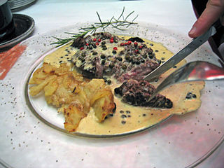 A beef steak served with peppercorn sauce