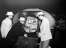 Photo of Texas Liquor Control Board agents viewing a stash of illegal alcohol.