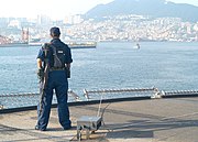 YN3 Tanya Enis stands force protection watch in Pusan harbor as USS Blue Ridge (LCC-19) makes a 2-day port call.