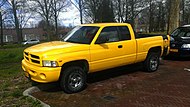 A yellow 1999 Dodge Ram 1500, resembling the "Rumble Bee"