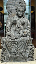 Statue of seated Hārītī with children from Yusufzai in the British Museum, 2nd–3rd centuries CE[2]