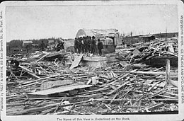 Black-and-white photograph showing piles of debris and splintered wood