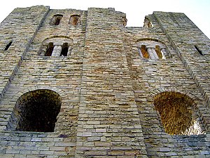 Limestone ashlar masonry in even courses at Scarborough Castle. The buttresses of low profile are characteristic of Romanesque building.
