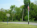 An American flag and historical marker at the entrance to the historic site