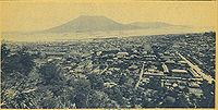 The city covered deep in ash after the 1914 eruption of the Sakurajima volcano which is seen in the distance across the bay
