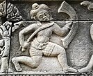 Bas-relief of soldier carrying a kukri and shield.