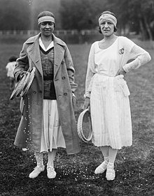 Mallory and Lenglen posing with rackets off the court in tennis attire