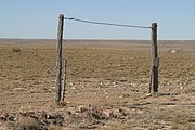 Gate leading to fenced pastureland in the wide open spaces south of Kenna, Roosevelt County, New Mexico.