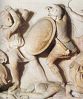 Ancient depiction on the Alexander Sarcophagus of a Macedonian infantryman (right) equipped with a typical Phrygian/Thracian helmet with a peak.