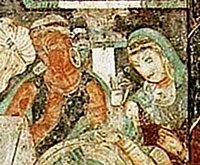 Treasure Cave 83, attendants, with ornate capital in the background (detail)