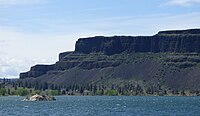 Tall dark escarpment above the lake