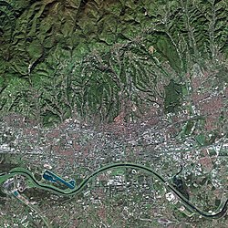 Satellite picture of Zagreb. Peščenica is on the northern side of River Sava, resembling a large whitish rectangular patch, northwards from the big white object next to the river.