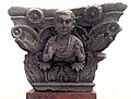 Indo-Corinthian capital representing a Buddhist devotee wearing a Greek cloak (chlamys) attached by a fibula. Dated to the 1st century BCE. Butkara Stupa.