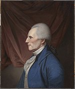 Portrait of a determined-looking man with white hair. He looks to the viewer's left with his head in profile.