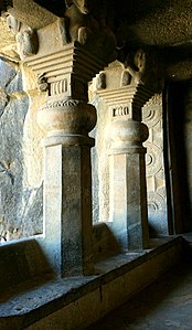 Cave No.3 pillars (back view). They have no base, and "stand on a bench in the veranda, and in front of them is a carved screen".[9]
